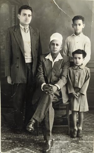 My father in the middle and my older siblings.